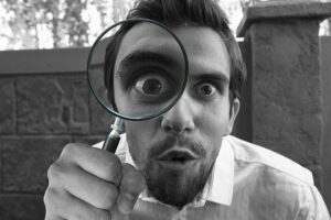 person looking through a magnifying glass